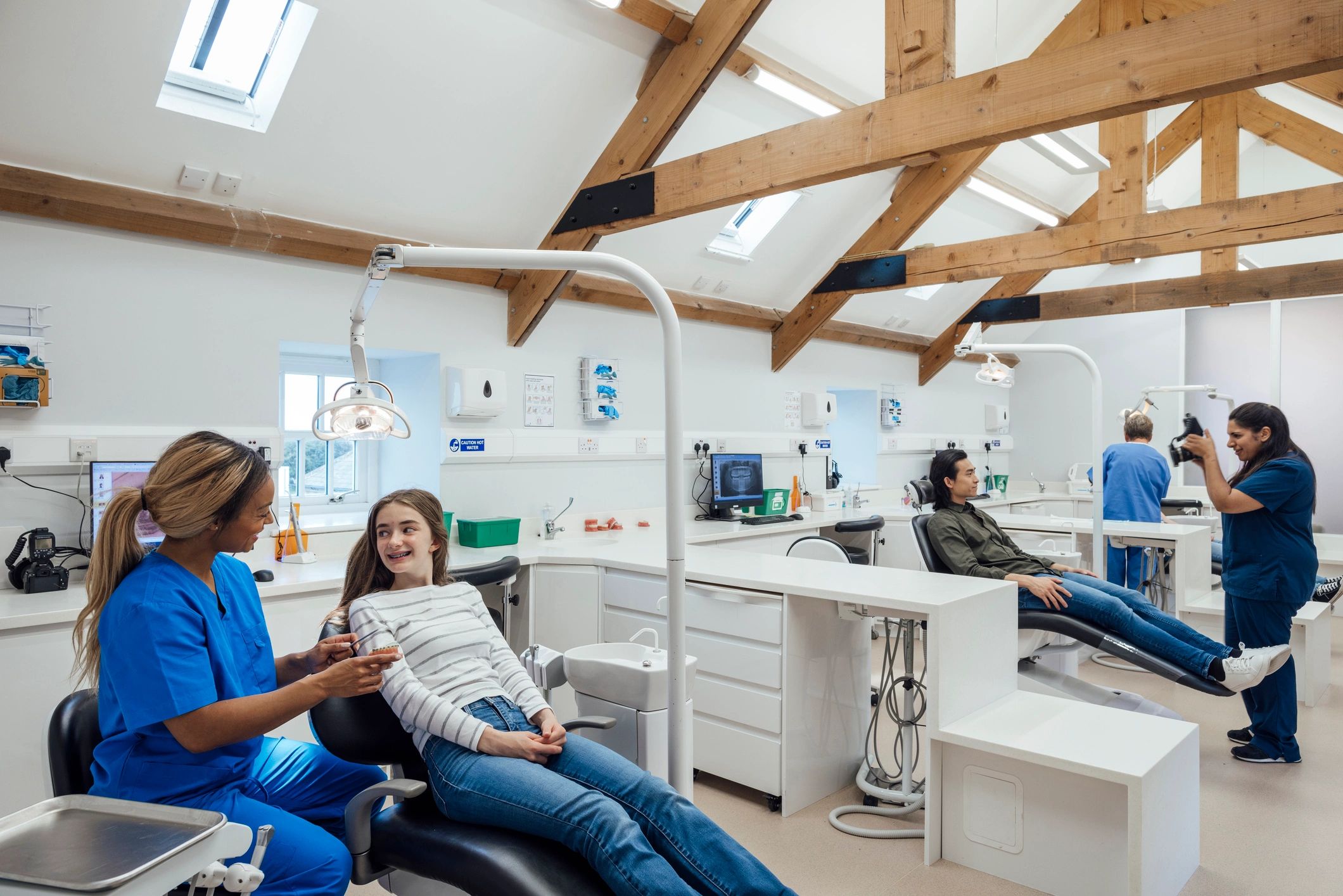 Asian dental team caring for patients in a busy clinic
